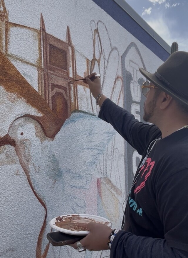 Victor Navarro working on the mural at Tucson Airport